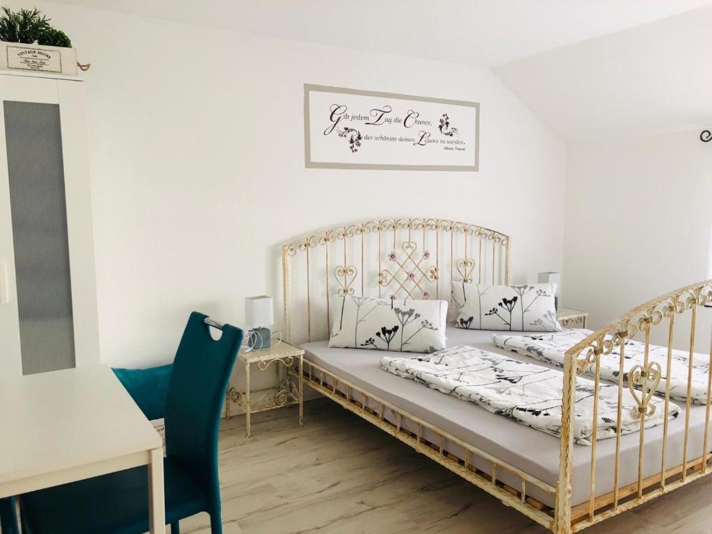 a bedroom with two beds and a table and a desk at Agnieszkas Pension in Havelberg