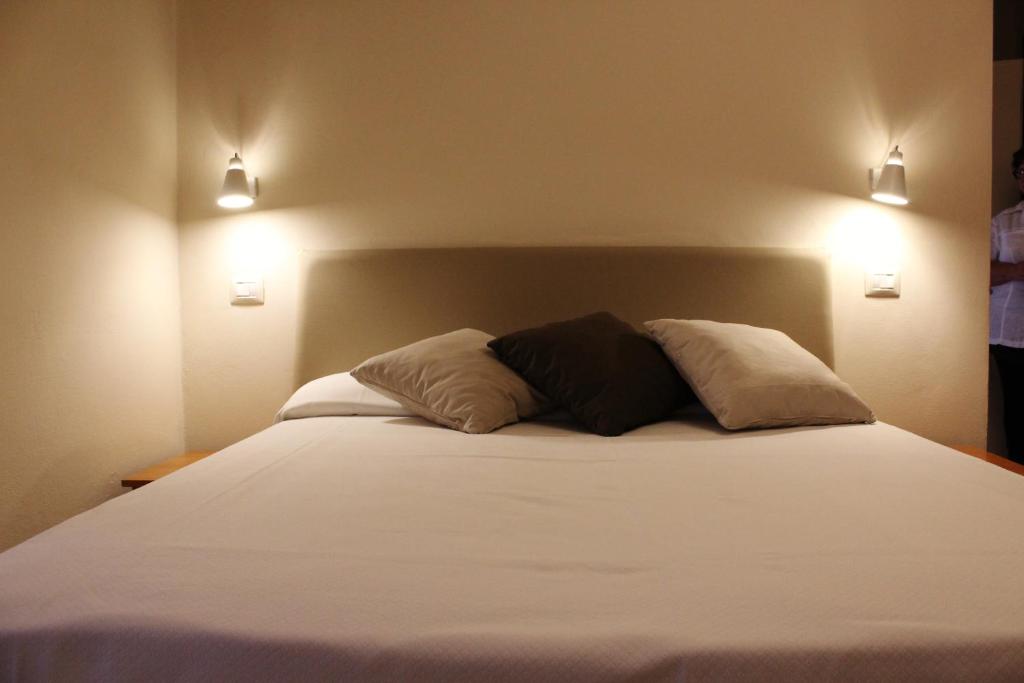 a bedroom with a bed with two pillows on it at Hotel Ristorante Il Gabbiano in Cecina