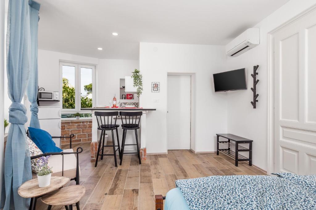 a living room with a bed and a kitchen at Apartment Villa Elena in Opatija
