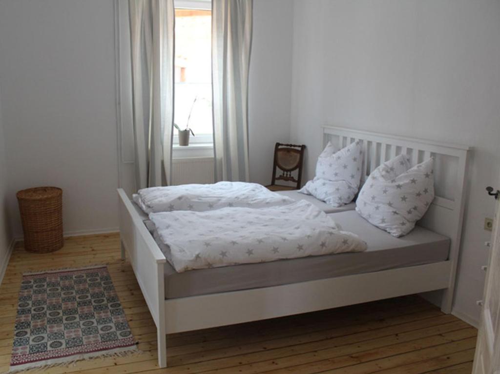 a white bed with white sheets and pillows in a bedroom at Posthof Kerstenhausen in Borken