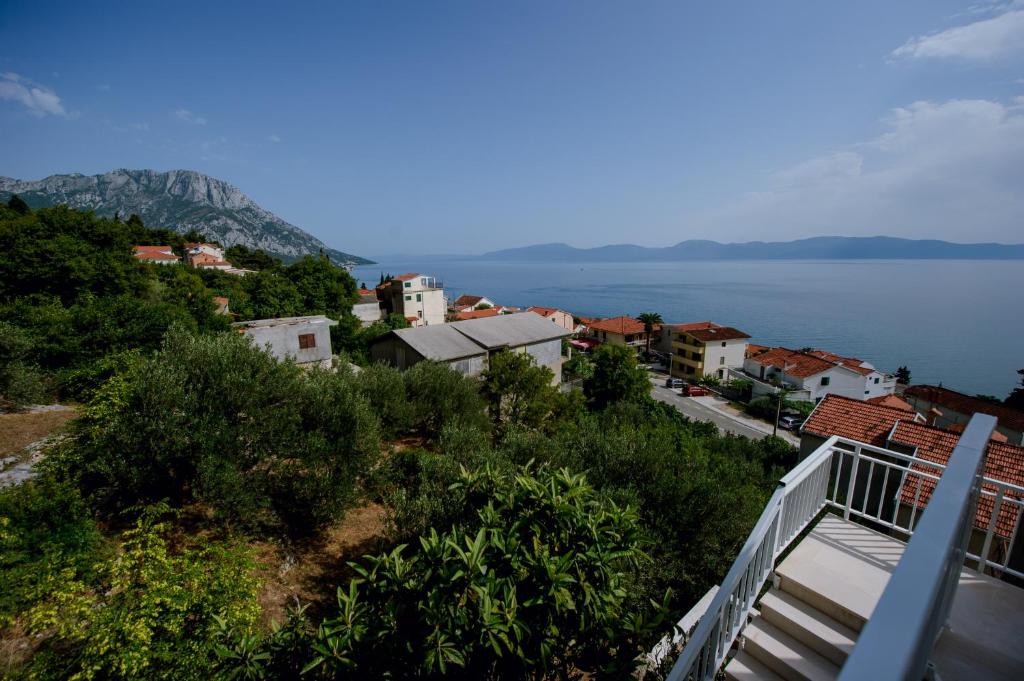 a view of a town on a hill next to the water at Pension Maric Rooms in Brist