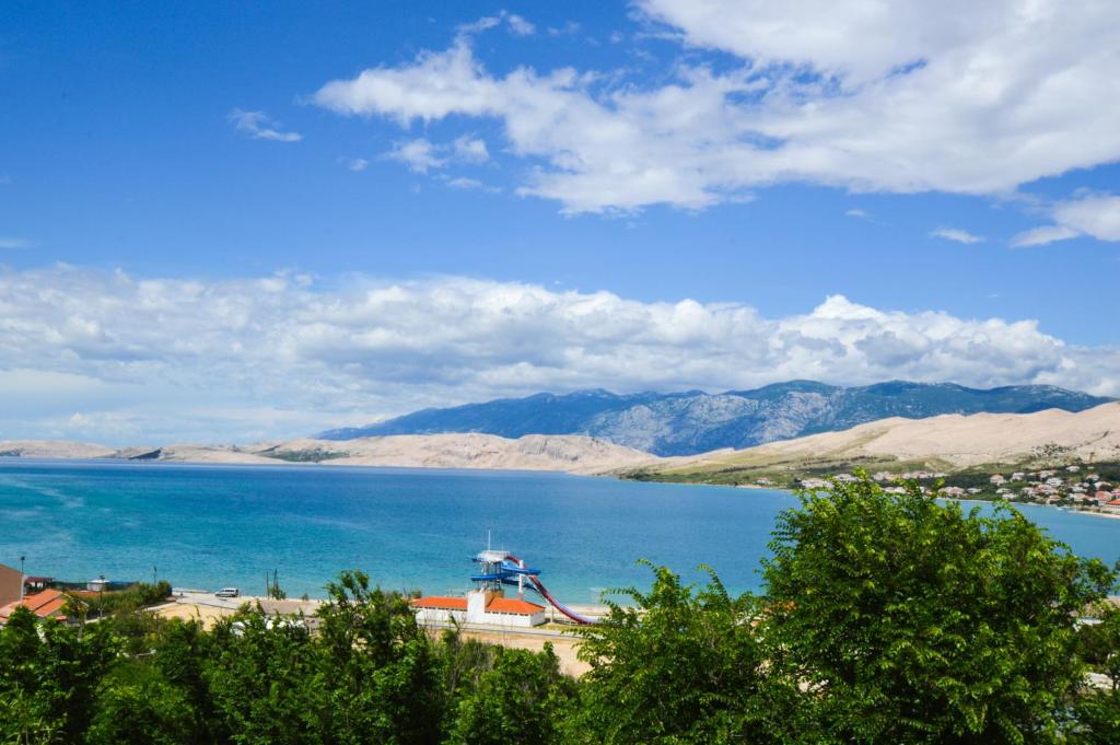 a view of a large body of water with mountains at Maja in Pag