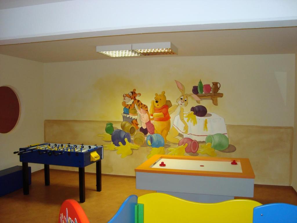 a room with a mural of winnie the pooh on the wall at Appartements Schedererhaus in Going