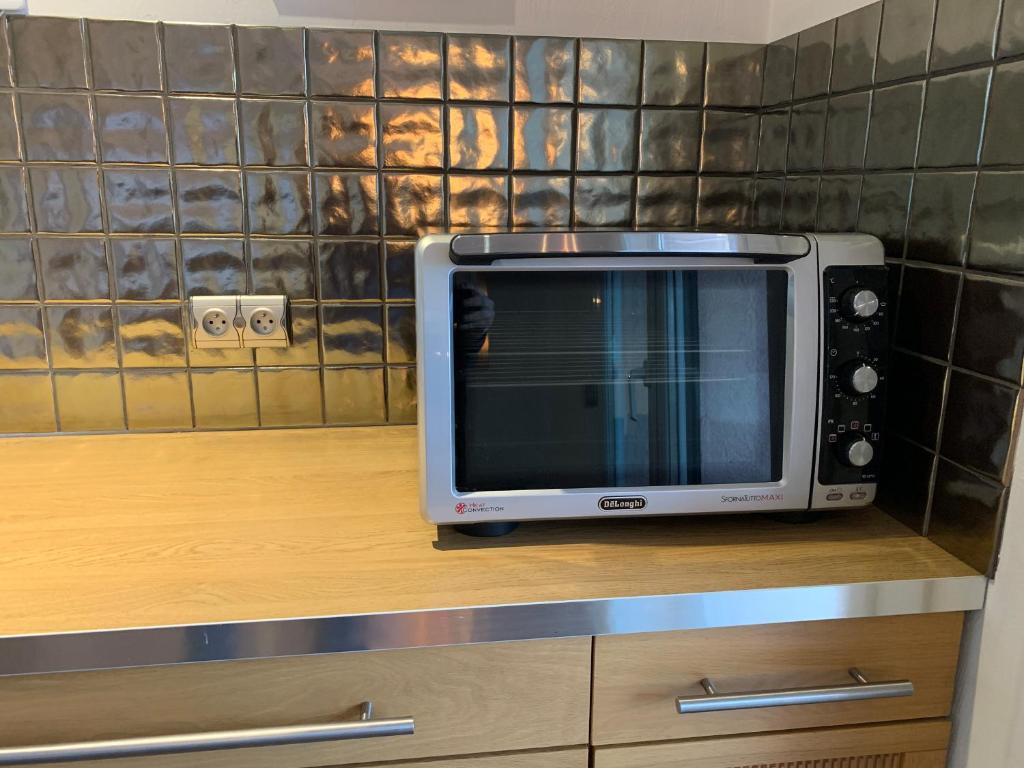 a microwave oven sitting on top of a cabinet at Villa Angel in La Gaude