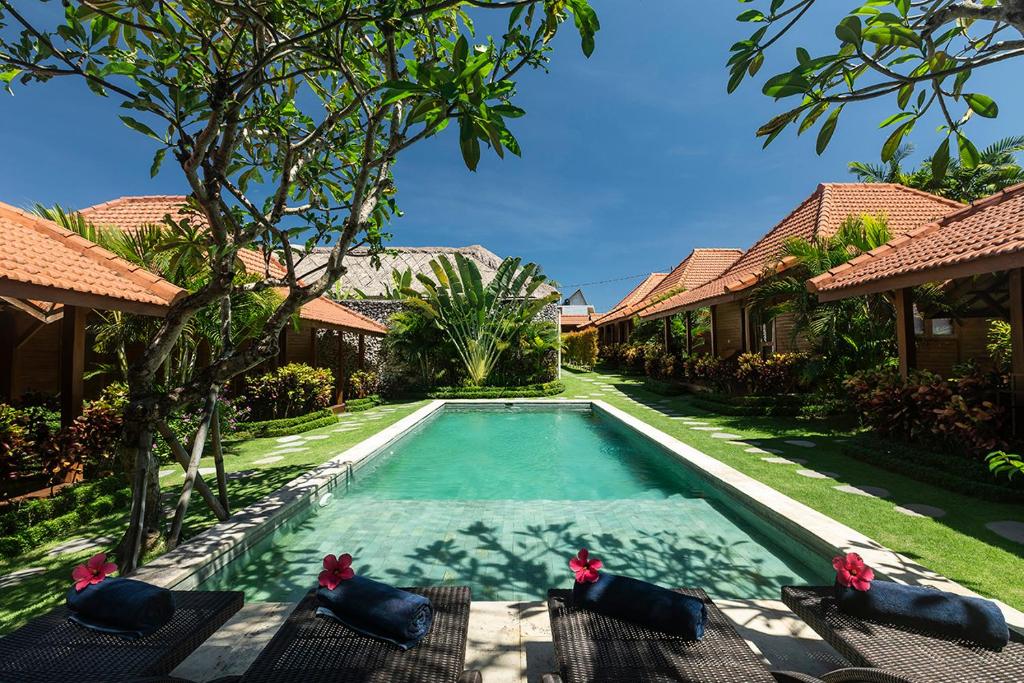 a swimming pool in the backyard of a villa at Orora Bungalows in Canggu