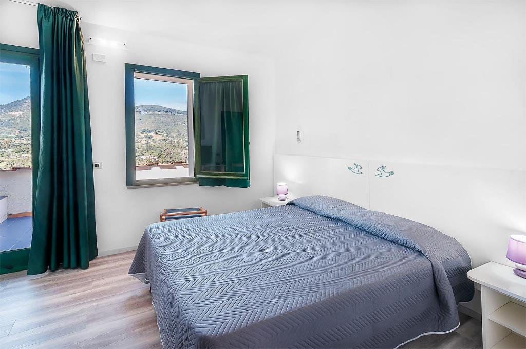 Postel nebo postele na pokoji v ubytování Hotel Capo Di Stella