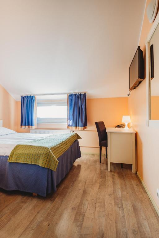 Postel nebo postele na pokoji v ubytování Economy Hotel