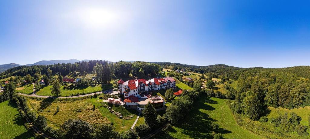 an aerial view of a large house in a green field at Dziki Potok Konferencje Grill & Prestige SPA in Karpacz