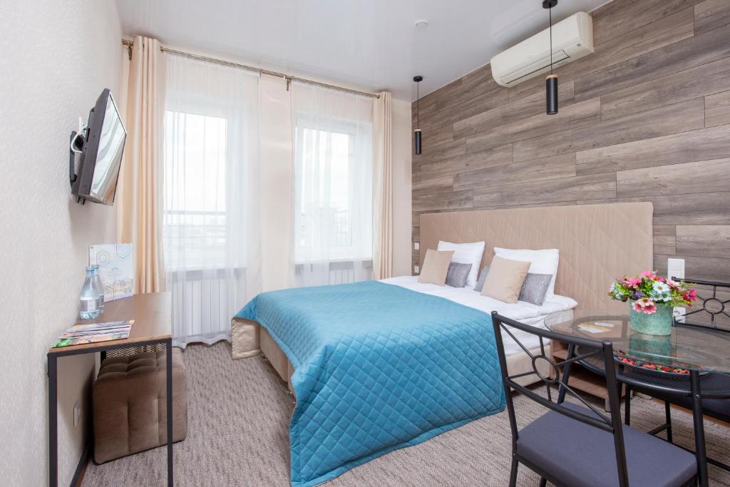 a hotel room with a bed and a table at Mix Hotels Nevsky 67 in Saint Petersburg