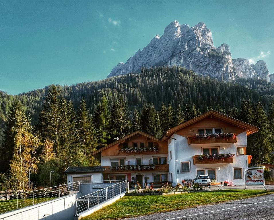 a building with a mountain in the background at Residence Trenker Luis in Braies