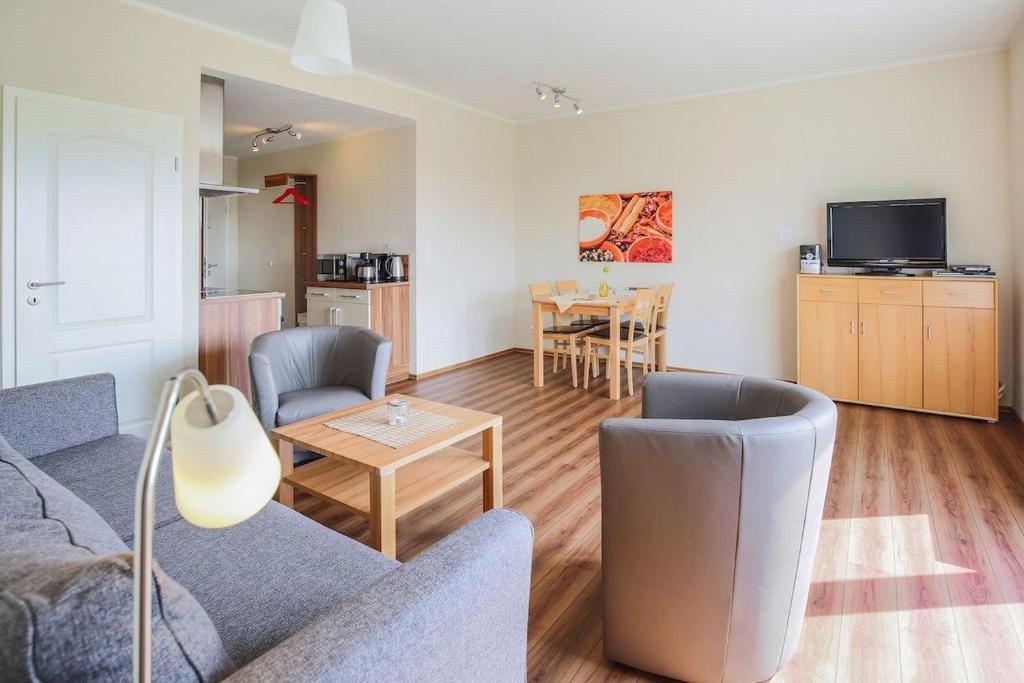 a living room with a couch and a table at Buedlfarm-Sued in Sahrensdorf