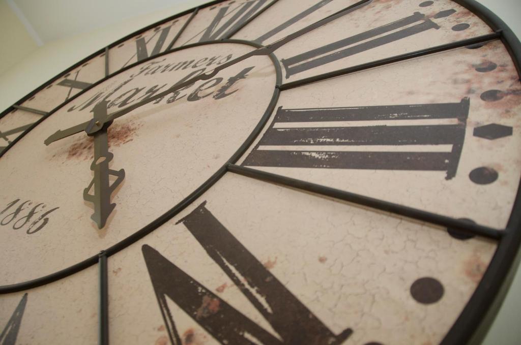 a large clock with roman numerals is shown at Casa do Relógio in Lousã