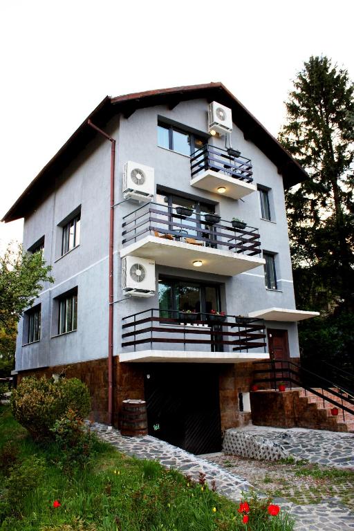 a building with balconies on the side of it at Bankya Guest House - Sofia in Bankya