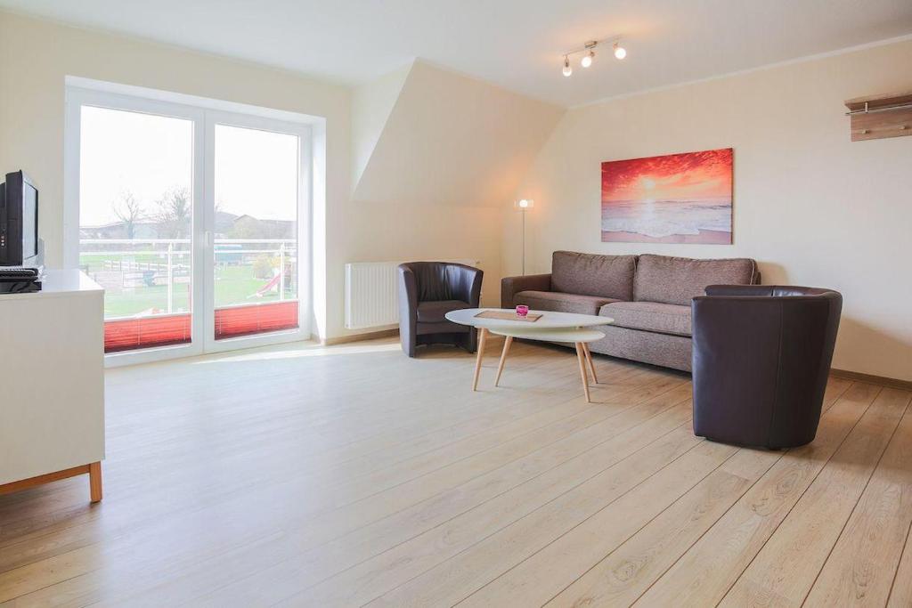 a living room with a couch and a table at Buedlfarm-Grosse-Wohnung in Sahrensdorf