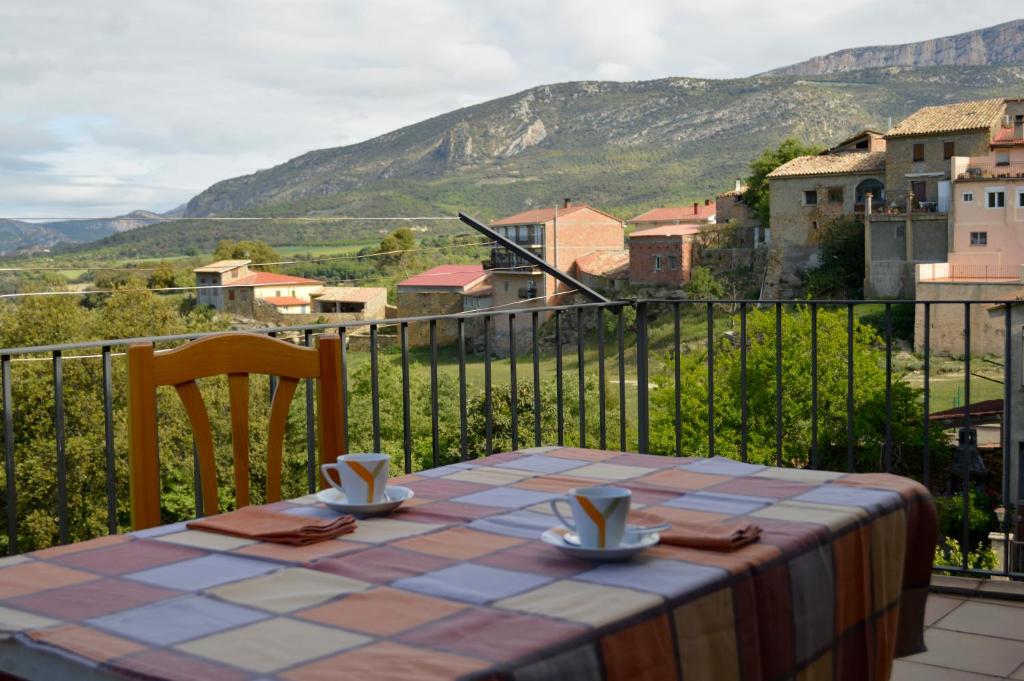 a table on a balcony with a view of a mountain at Casa Ros in Agullo