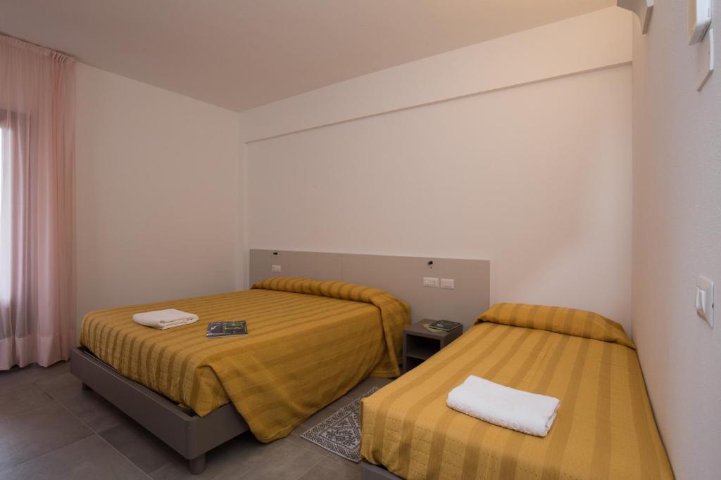 Postel nebo postele na pokoji v ubytování Hotel Ispinigoli