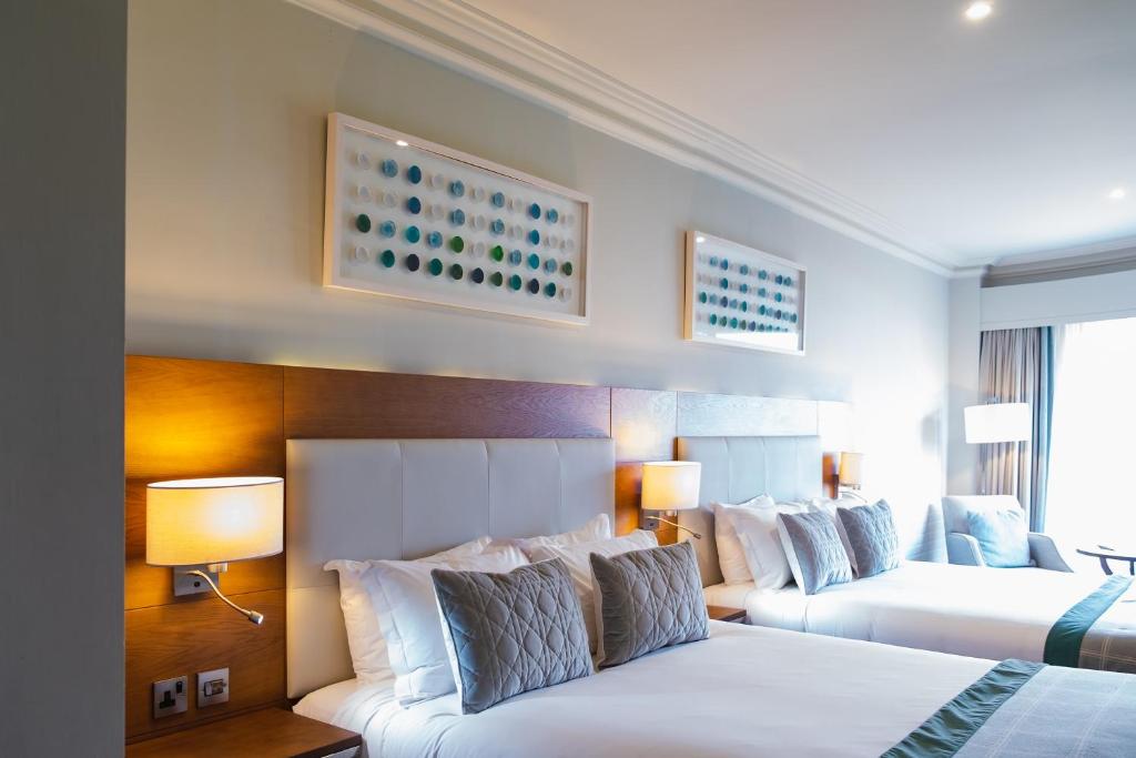 a hotel room with two beds and two lamps at Portmarnock Resort & Jameson Golf Links in Portmarnock
