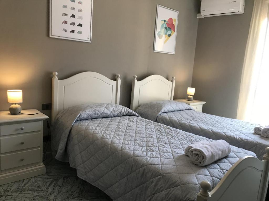 A bed or beds in a room at Anfite Apartments Castelletto