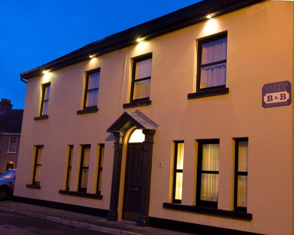 a large white building with a black door at Griffin Lodge Guesthouse in Galway