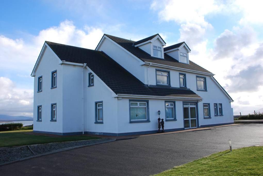 a large white house with a black roof at Kemar House in Belmullet
