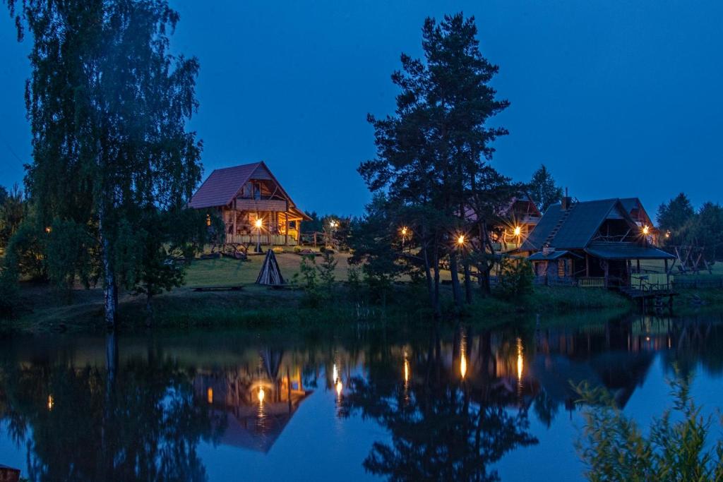 une maison sur la rive d'un lac la nuit dans l'établissement Miego klinika 2 -POILSIUI be triukšmo visą parą, à Kelmė