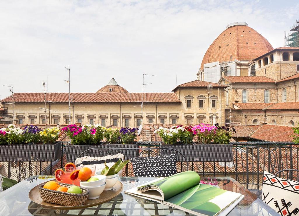 einen Tisch mit einer Obstschale auf dem Balkon in der Unterkunft Best Location w/ Breathtaking Views Chic Palace in Florenz