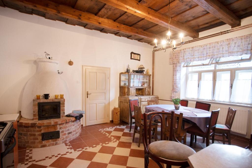 a living room with a table and a fireplace at Vazsita ház in Erdőbénye