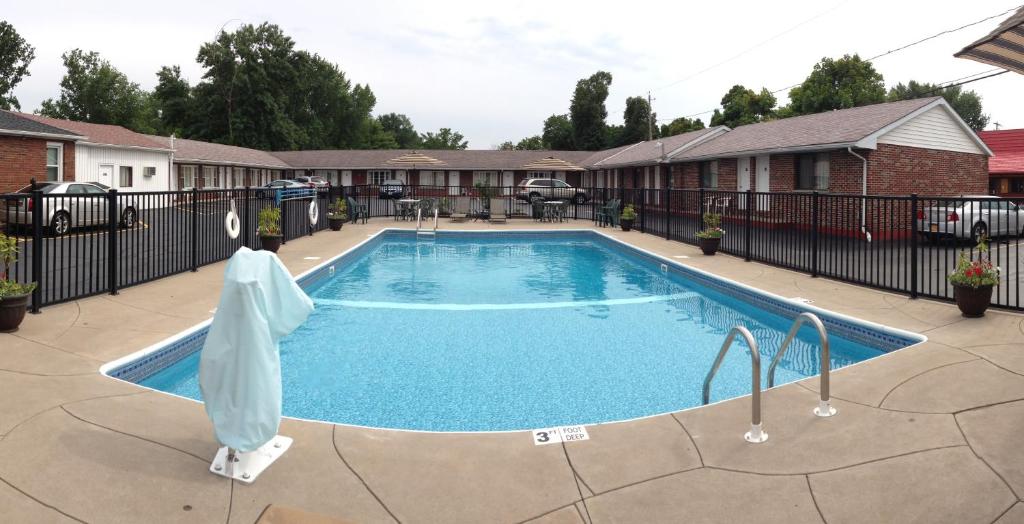 a large swimming pool in a yard with a fence at Moonlite Motel in Niagara Falls