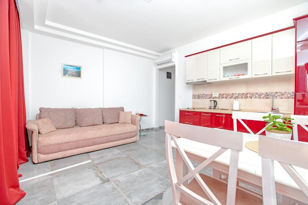 a living room with a couch and a kitchen at Apartments Castello in Kotor
