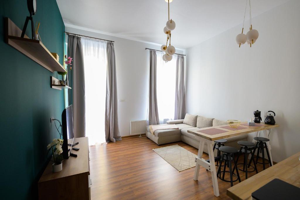 a living room with a couch and a table at UNIRII OLD SQUARE APARTMENTS 4 in Timişoara