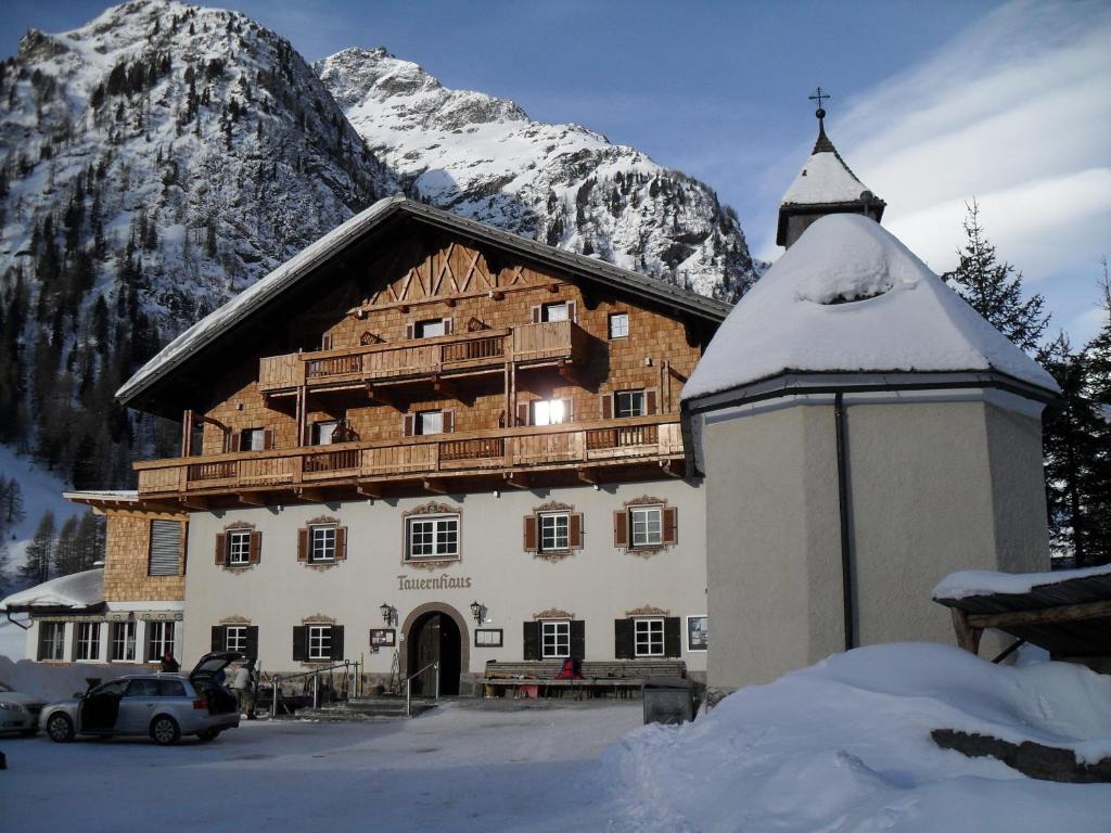 a large building in front of a mountain at Matreier Tauernhaus in Matrei in Osttirol