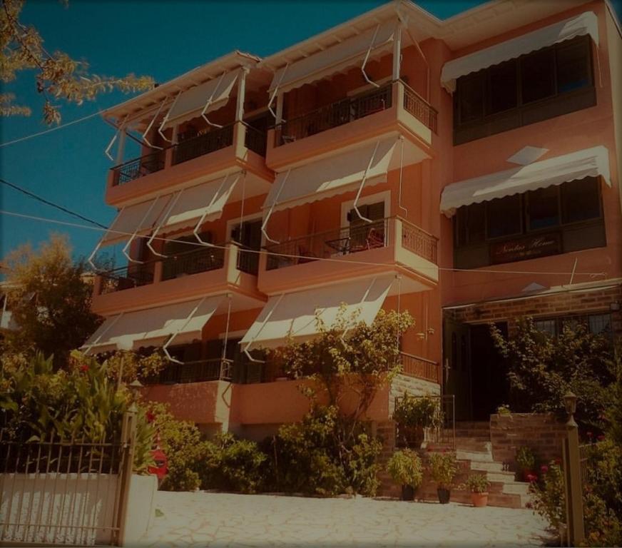 an orange building with stairs in front of it at Nontas Home in Kalamitsi