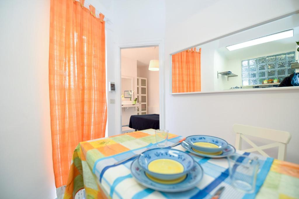 a table with dishes on it in a room at Le Querce in Procida