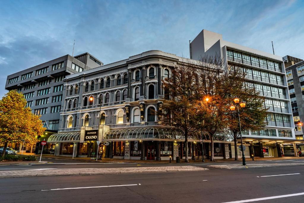 a large building on a street in a city at Scenic Hotel Southern Cross in Dunedin