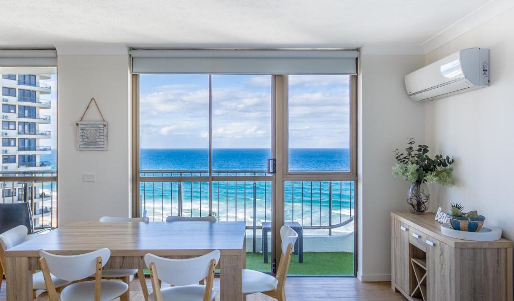 a dining room with a table and a view of the ocean at Ocean Royale in Gold Coast