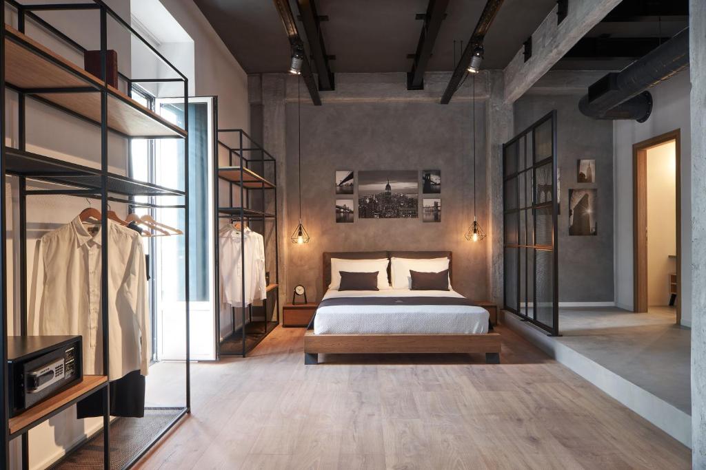 a bedroom with a bed and some glass shelves at Kolonaki 8 - Design Suites & Lofts in Athens