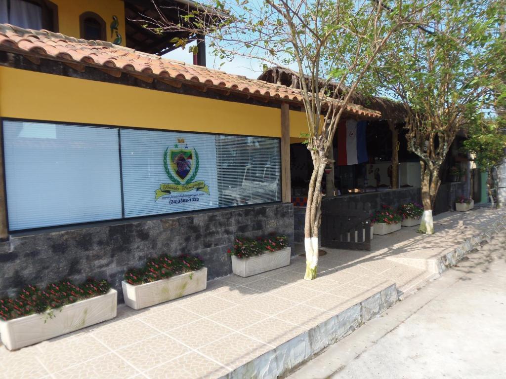 a building with a sign on the side of it at Pousada Paraguaya in Angra dos Reis