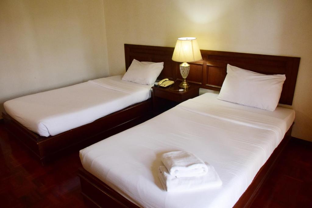 Postel nebo postele na pokoji v ubytování Puangpen Villa Hotel