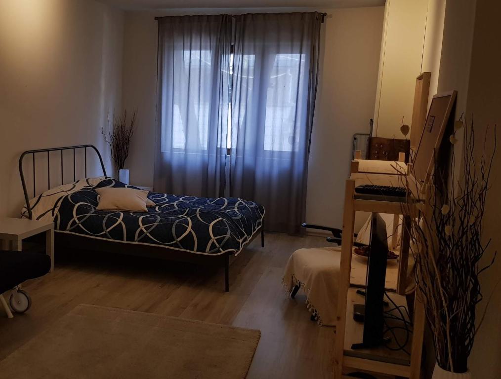 a bedroom with a bed and a window with curtains at Red Door Apartment in Sofia
