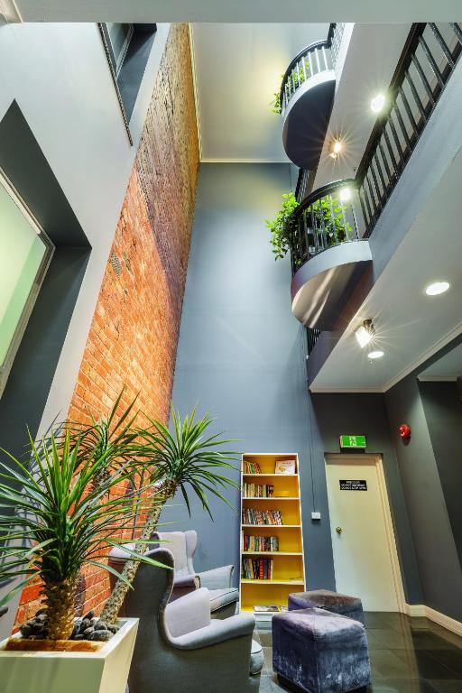 an office lobby with stairs and plants at Best Western Melbourne City in Melbourne
