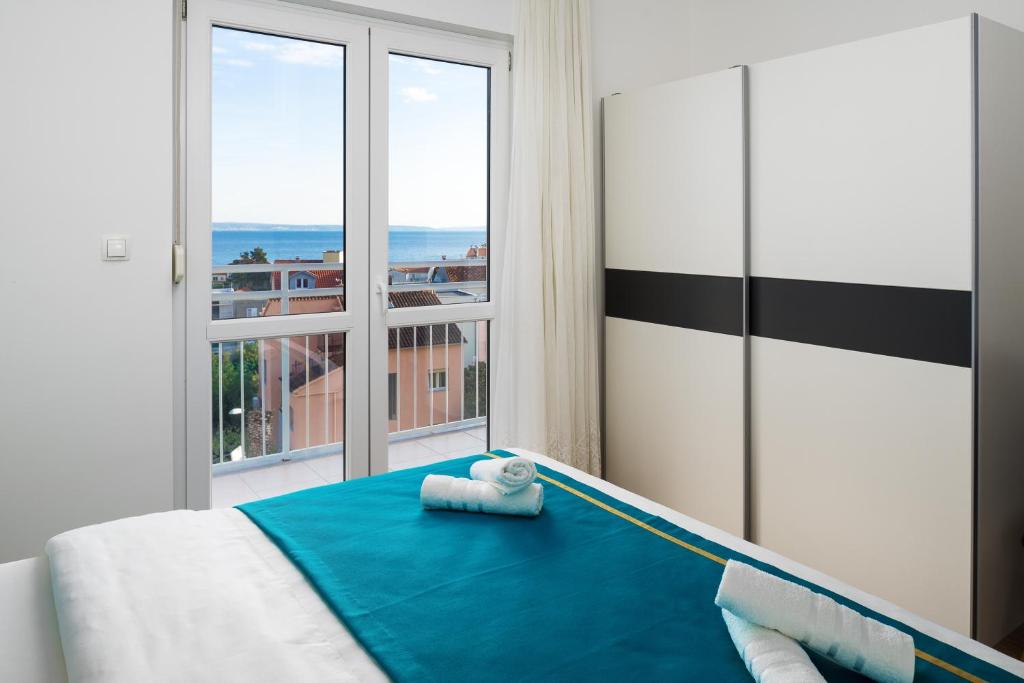 Posteľ alebo postele v izbe v ubytovaní Lotus Apartman
