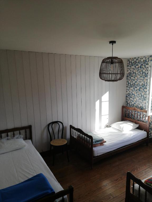 a bedroom with two beds and a pendant light at Gite Compostella in Saint-Jean-Pied-de-Port
