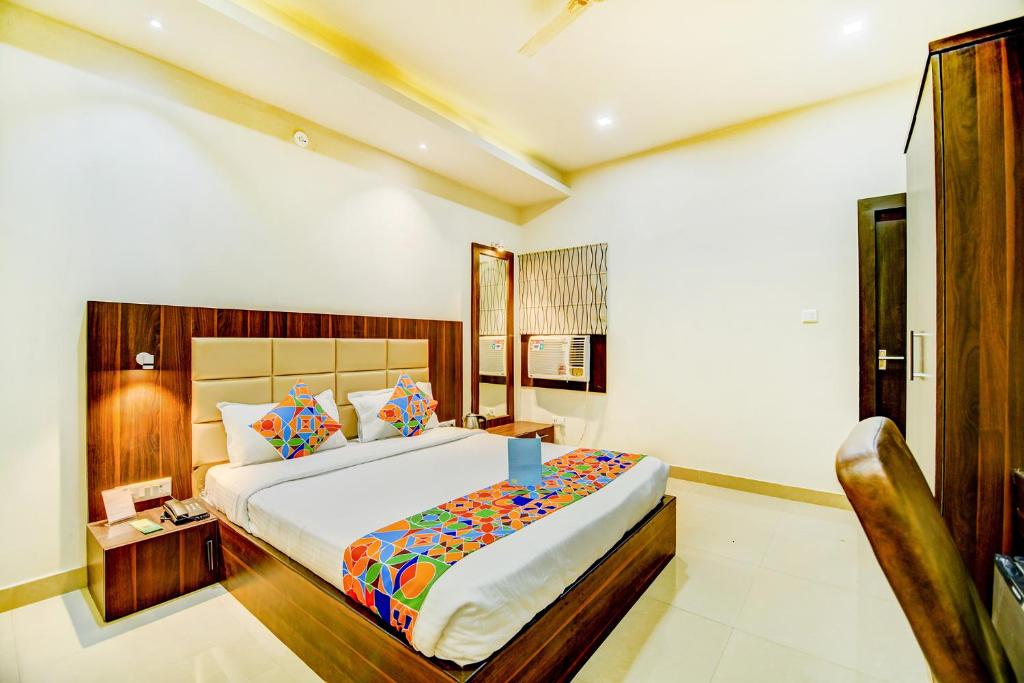 a bedroom with a large bed in a room at FabHotel Solitaire Inn in Kānpur