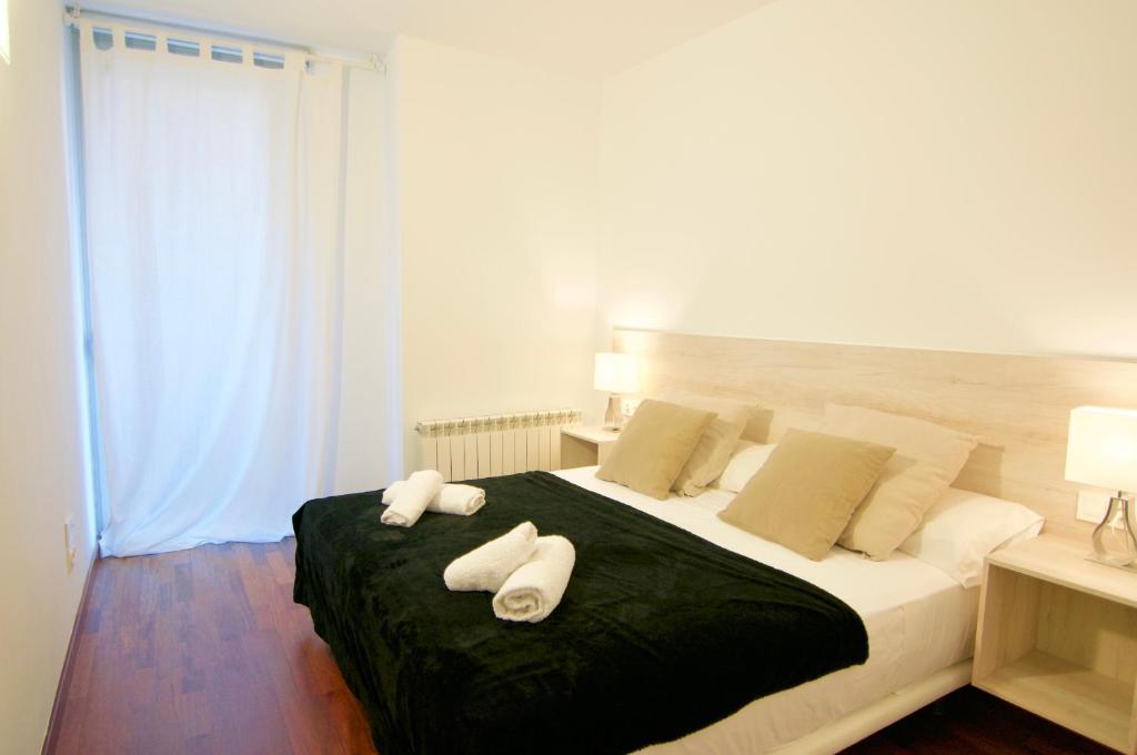 Postel nebo postele na pokoji v ubytování Glasir Apartments Barcelona