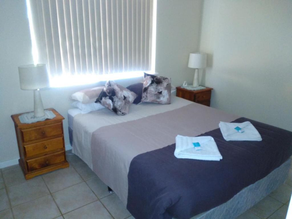 a bedroom with two beds with towels on them at Ocean Beach Chalet 15 in Jurien Bay