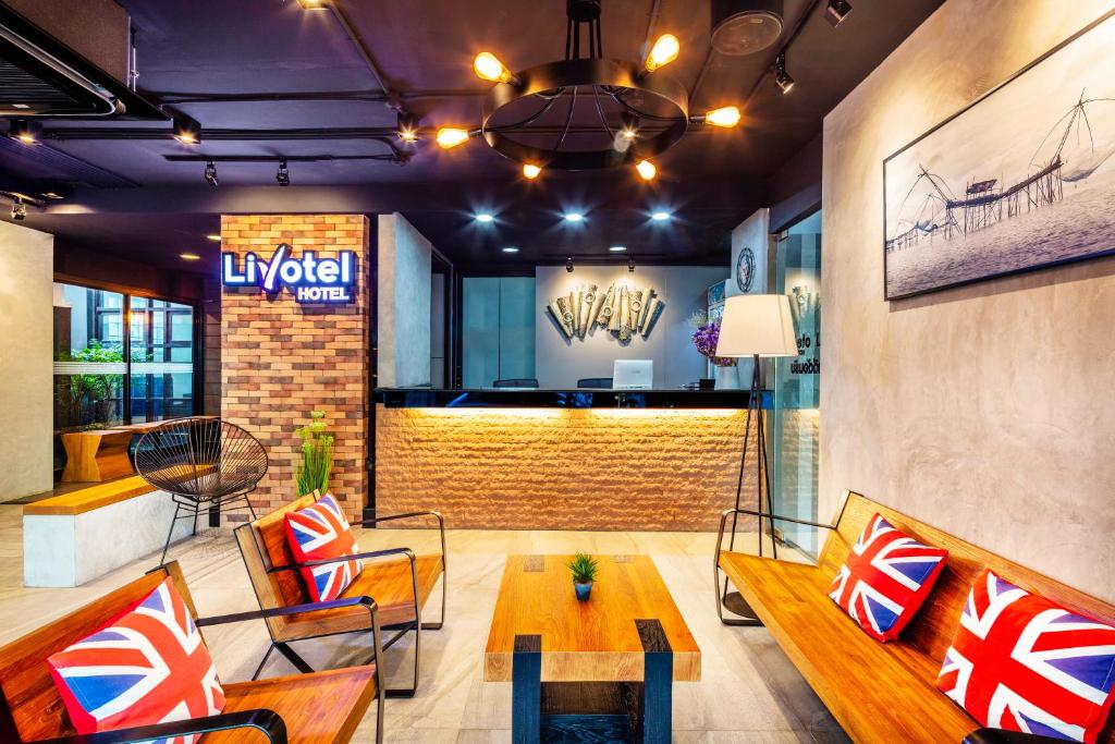 a lobby of a luxury hotel with a table and chairs at Livotel Express Hotel Bang Kruai Nonthaburi in Nonthaburi