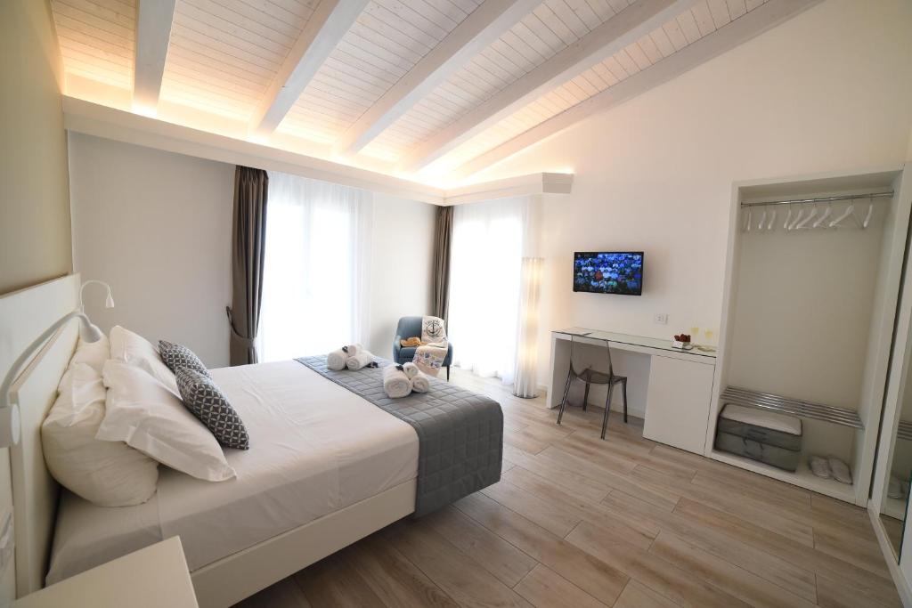 a bedroom with a bed and a desk with a television at La Torre del Mulino - SUPERIOR Rooms in Tropea
