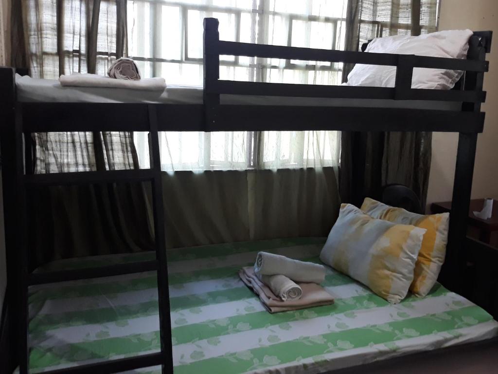 a bunk bed with a pair of shoes on the bottom bunk at CVNB guesthouse in San Juan