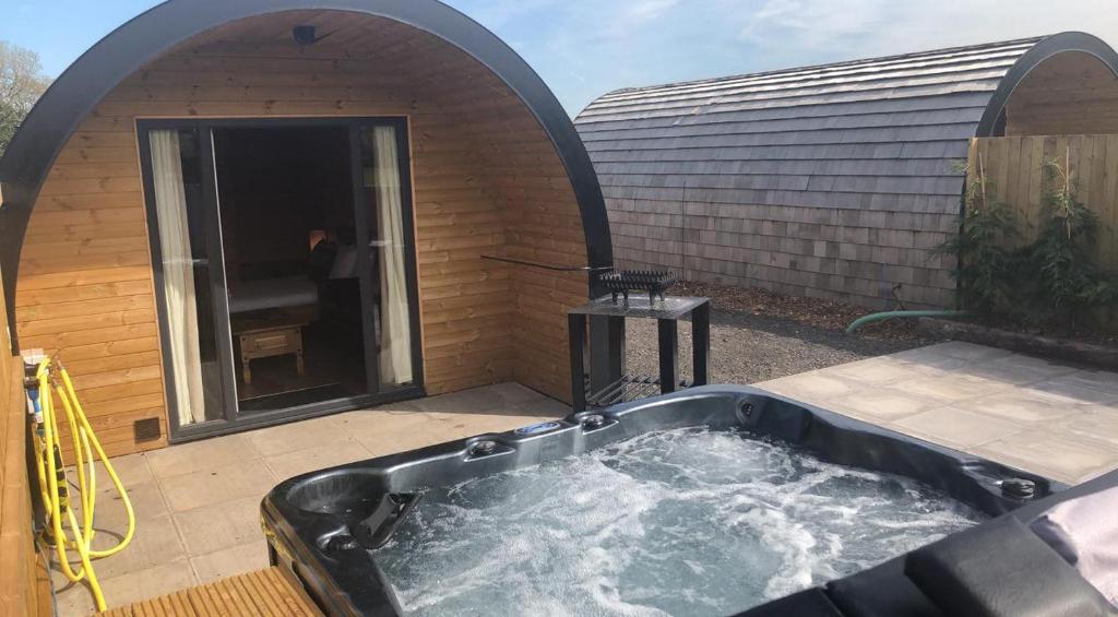 a hot tub in the backyard of a house at Superior Glamping Pod with Hot Tub in Frodsham