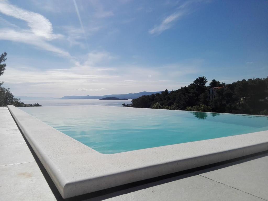 a swimming pool with a view of the water at Holiday Hvar in Vrbanj